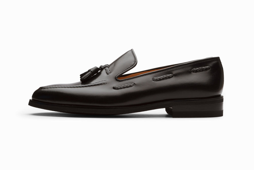 Black leather tassel loafers — side profile — handcrafted in Delhi